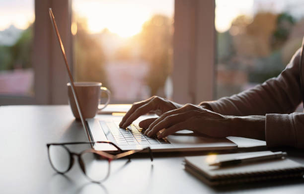 istock Woman working in office. Student girl using laptop computer at home 1472762403