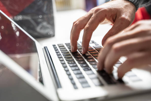 istock hands of a man typing on a laptop 1472764253