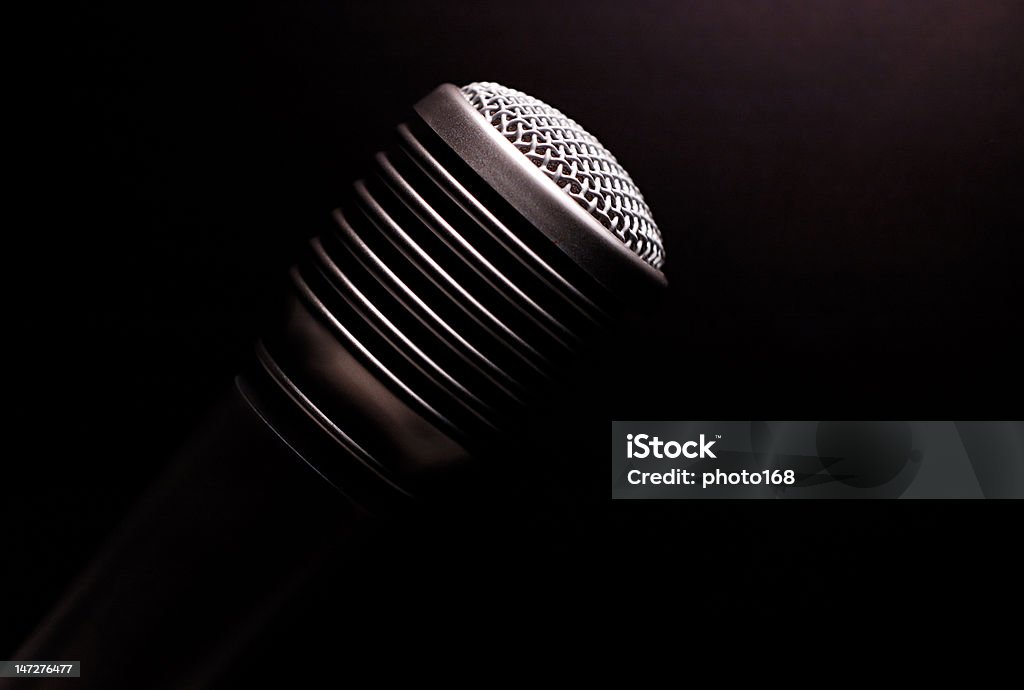 microphone close-up of microphone with black background Audio Equipment Stock Photo