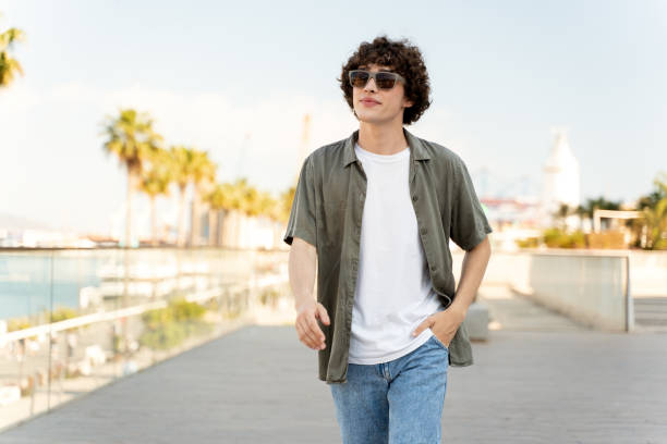 istock Hipster guy wearing casual clothes enjoys relaxing on a summer weekend 1472769245
