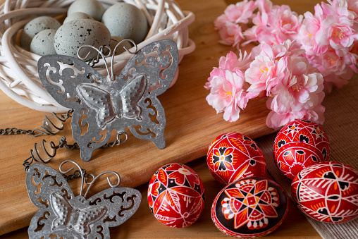 hand painted red sorbian easter eggs and easter decoration on a table