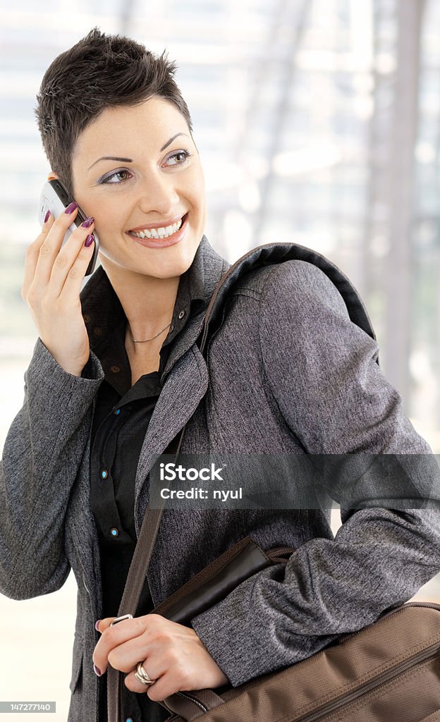 Businesswoman calling on mobile Portrait of happy young businesswoman calling on mobile phone, smiling. Click here for more Business images: 20-29 Years Stock Photo