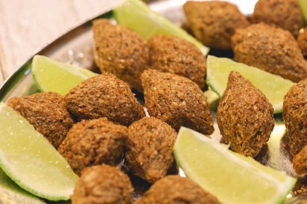 istock Small fried kibbeh with pieces of lemon served at the table. 1472772045