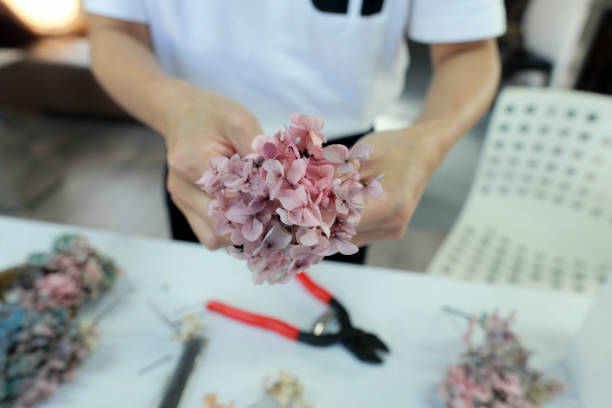 istock A female florist is making a wreath with hydrangeas 1472772562