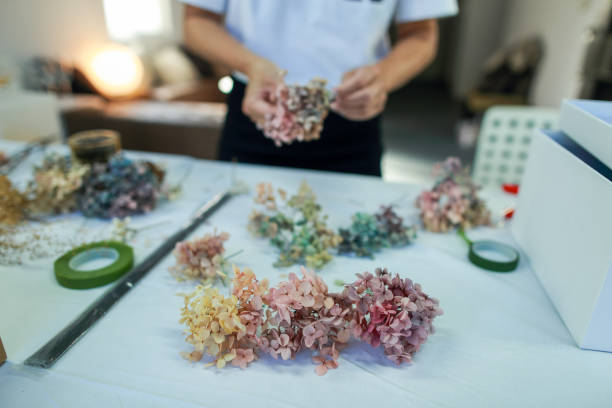 istock A female florist is making a wreath with hydrangeas 1472772573