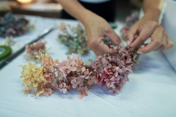 istock A female florist is making a wreath with hydrangeas 1472772576