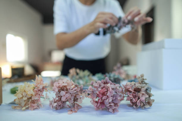 istock A female florist is making a wreath with hydrangeas 1472772595