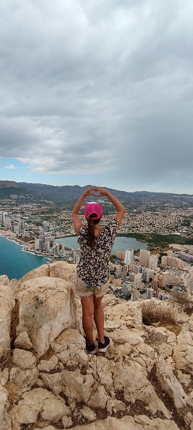 Image of a woman in the top of the famous Peñón d'ifach in Calpe