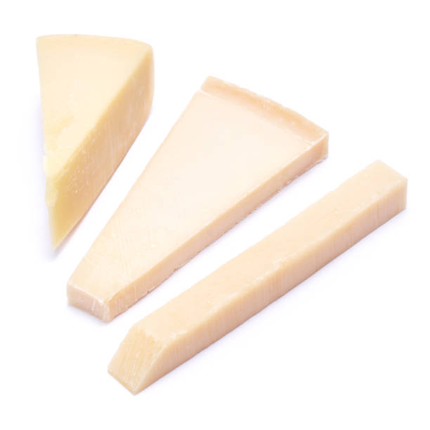 istock Pieces of parmesan cheese isolated on white background 1472776169