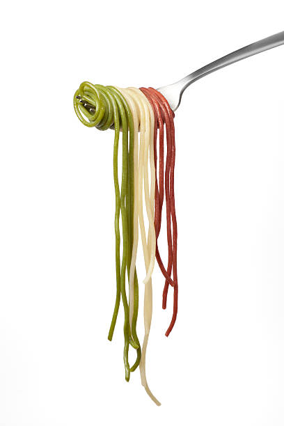 Fork draped with tricolor cooked spaghetti