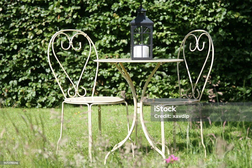 Garden table White garden table and chairs Bush Stock Photo