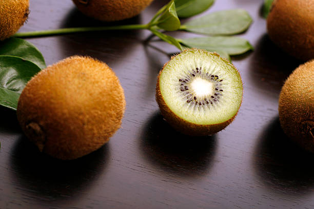 Open kiwi piece on a table stock photo