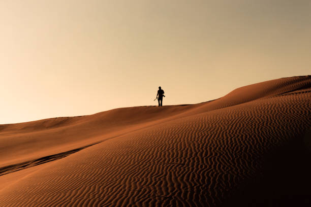 istock Man walking in the desert 1472788212