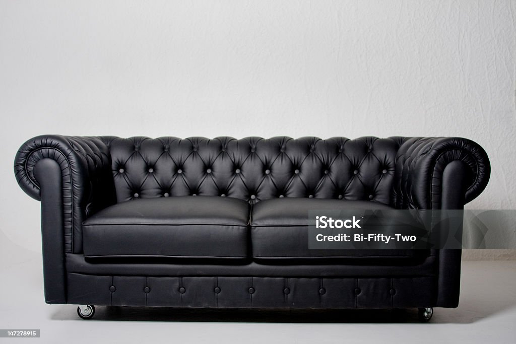 Long black leather sofa on white background Black sofa Sofa Stock Photo