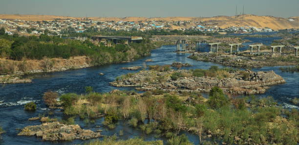 View of Nile from the dam southly of Aswan in Egypt, Africa View of Nile from the dam southly of Aswan in Egypt, Africa panoramic riverbank architecture construction site stock pictures, royalty-free photos & images