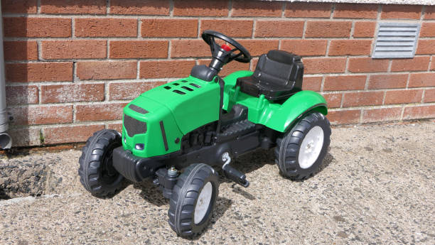 istock Childrens tractor toy in garden 1472790042