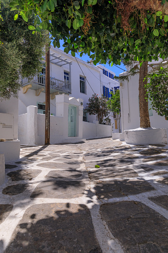 Traditional  streetview of Mykonos old town with white house and blue door.