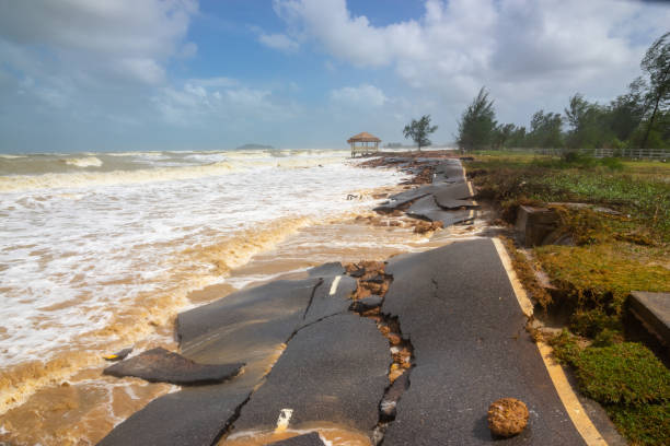 istock Waves of sea erode the road, 1472790813