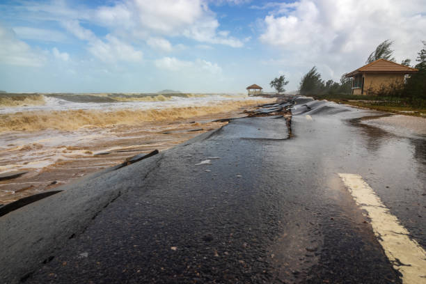 istock Waves of sea erode the road, 1472790816