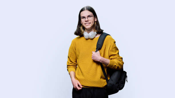 istock Portrait of university student guy on light studio background 1472791861