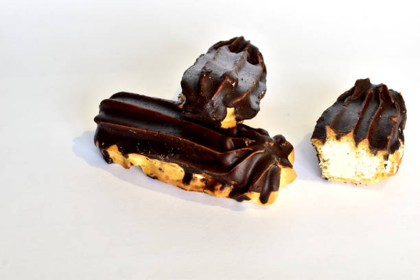 istock Custard cakes with butter cream and chocolate fudge. 1472792621