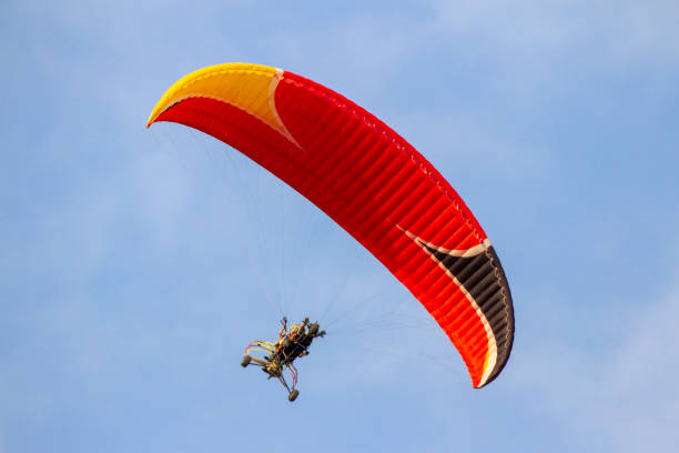 istock Paraglider With Engine Is Flying In The Blue Sky. 1472794229