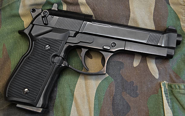 istock Black gun on camouflage 147279453