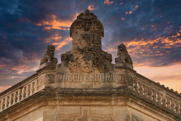statues at hotel espanol from 1914 under cloudy sky
