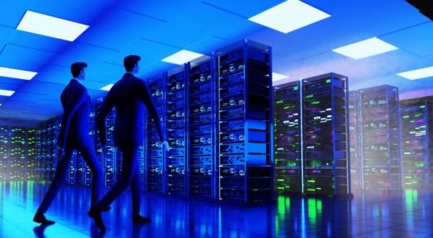 istock Two businessmen walking  in big modern server room, data centre or mining farm, controlling the working process. 3D rendering illustration 1472801484