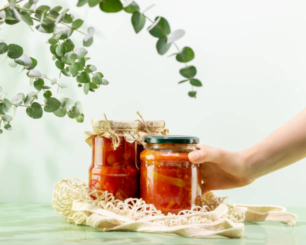 istock Woman hand holds pickled or fermented vegetable on mesh bag 1472802959