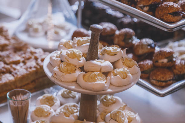 Meringue dessert Pavlova cookies on a service stand at a celebration buffet