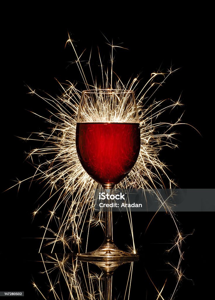 Glowing red wine and firework Glowing red wine glass and firework on black background No People Stock Photo