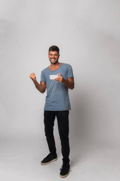 istock young man celebrating victory in online game 1472808142