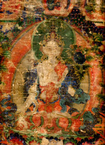 A Tibetan religious painting on fabric, usually portraying the Buddha or lamas in stereotyped aspects. This is an 18th century antique Tibetan Buddhist Tanka, collection of the photographer.