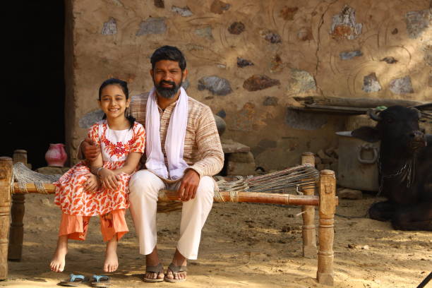 istock happy father and daughter siting together looking at camera 1472810752