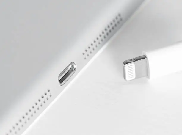 Photo of Apple Lightning Connection port on iPad. Connection used to connect mobile devices such as iPhones, iPads or iPods to computers.