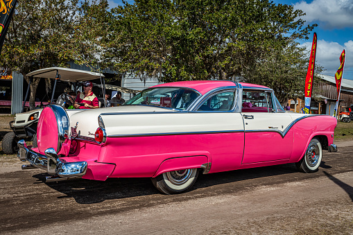 Fort Meade, FL - February 26, 2022: High perspective rear corner view of a 1955 Ford Fairlane Crown Victoria 2 Door Sedan at a local car show.