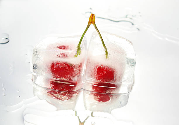 Cherry inside of dry ice cube isolated on white background