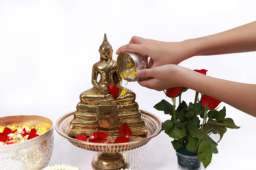 Sprinkle water onto a Buddha image, Asia culture to respect Buddha , Sonkran festival ,Buddhist Holy Day or Buddhist Sabbath Day