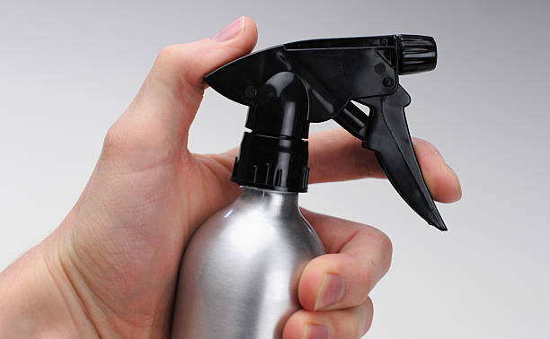 Hand on Spray Bottle stock photo