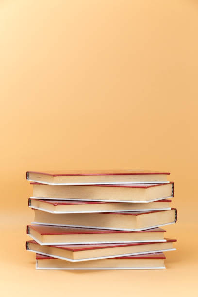 istock stack of red cover books on a yellow background 1472816898