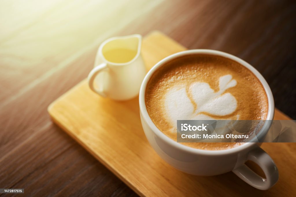 Hot latte art on wood table Cappuccino Stock Photo