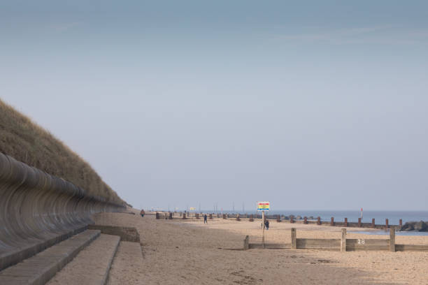Horsey, Norfolk, England, United Kingdom - February 15, 2013: People on a beach at Horsey Gap, Norfolk, in winter.