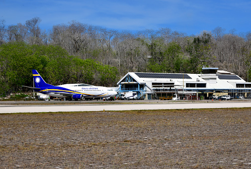 Yaren, Nauru: Republic of Nauru International Airport with a Nauru Airlines (the flag carrier) .Boeing 737-300 on the apron (VH-XNU) The airport was built in 1943 by the Japanese administration of the island.