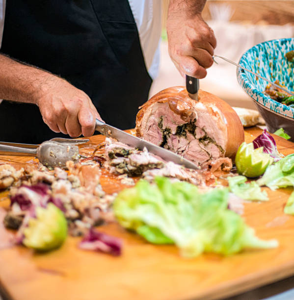 Man slicing Porchetta.