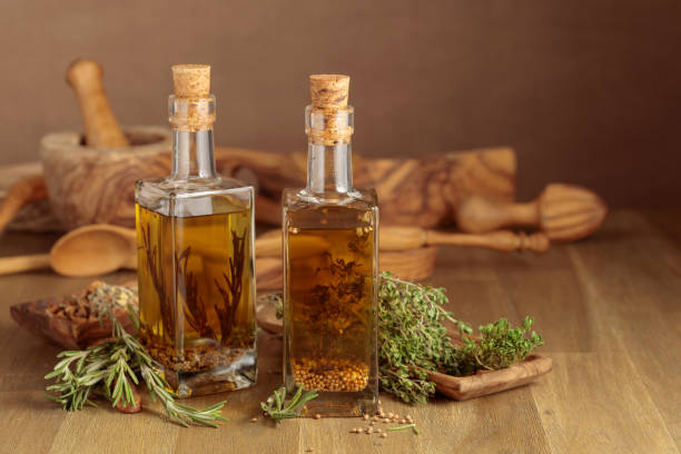 Bottles of olive oil with herbs and spices. stock photo