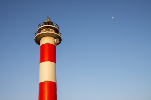 Traditional design with white and red stripes. The newest lighthouse of three of them in the northwest part of the island. El Cotillo, Fuerteventura, Canary Islands.