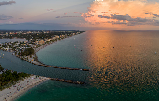 High angle view of crowded Nokomis beach in Sarasota County, USA. Many people enjoing vacations time swimming in ocean water and relaxing on warm Florida sun at sundown.