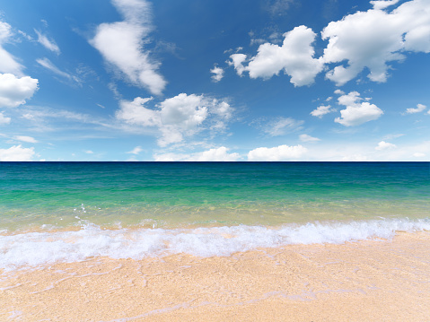 Beautiful seashore with clean yellow sand. Calm water surface. Sunny day with rare clouds. Theme for recreation, tourism, nature, advertising.
