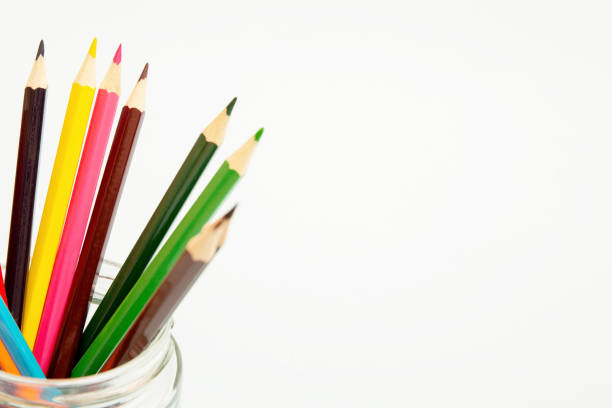 istock Multi-colored pencils in a glass jar on a white background. Copy space 1472826051